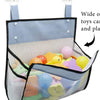 A hanging mesh bag organizer filled with various colorful bath toys and plastic items.