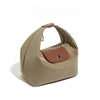 A beige nylon dumpling crossbody shoulder bag with a brown accent patch and zipper.