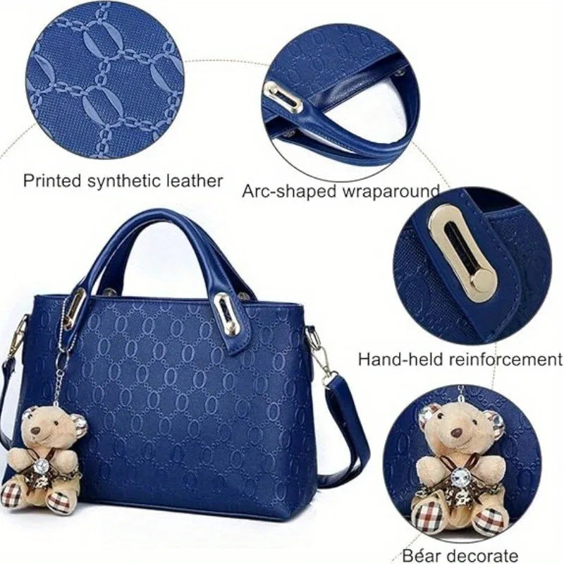 A dark blue embossed synthetic leather handbag set featuring a wallet and bear decor