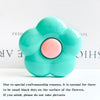 A light blue flower-shaped phone grip ring stand with small black dots on the surface.