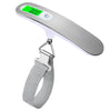 A portable digital luggage scale with a silver body and a green display, attached to a gray strap.