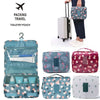 A set of multi-compartment floral print travel pouches in various shades of blue, pink, and green.