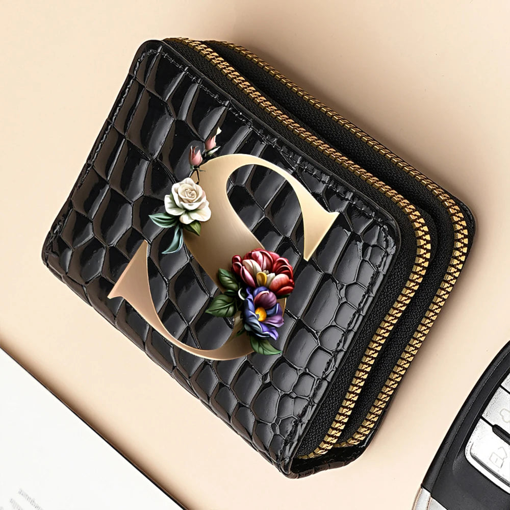 A black PU leather double-zip clutch wallet with a gold accent and a floral cartoon print.