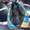 A vintage sunflower quilted duffle bag with multicolored floral patterns and a black interior.