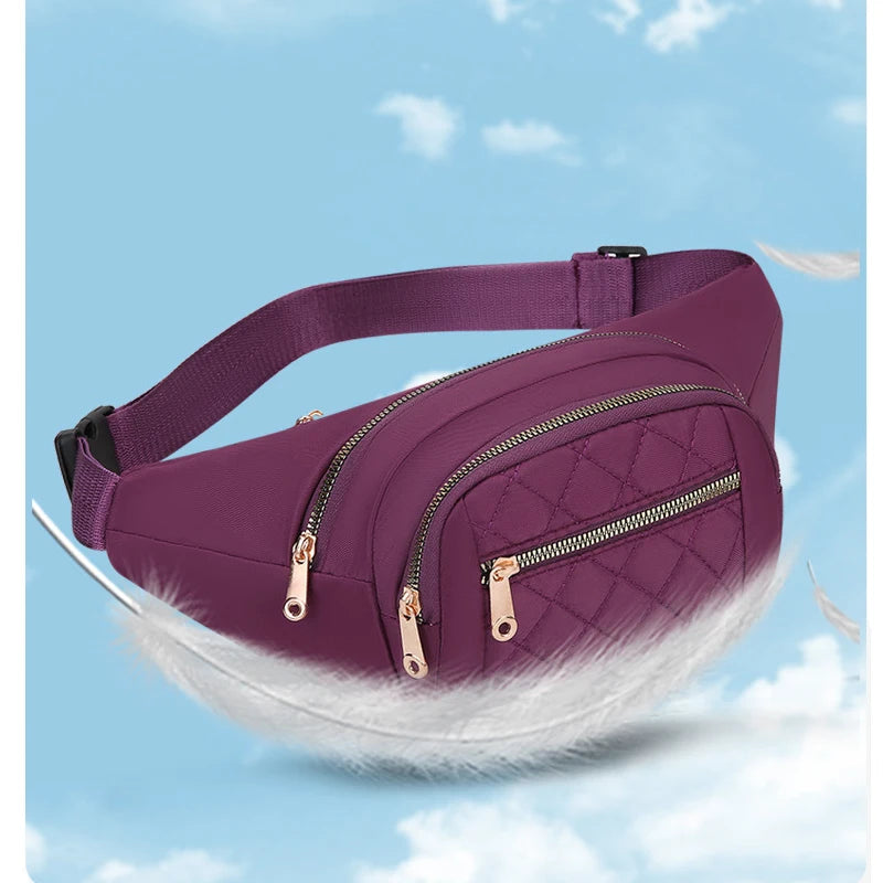 A purple quilted nylon crossbody belt bag with a white fluffy trim is shown against a light blue sky background.