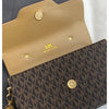 A tan Michael Kors letter square crossbody bag with gold hardware resting on a white surface.