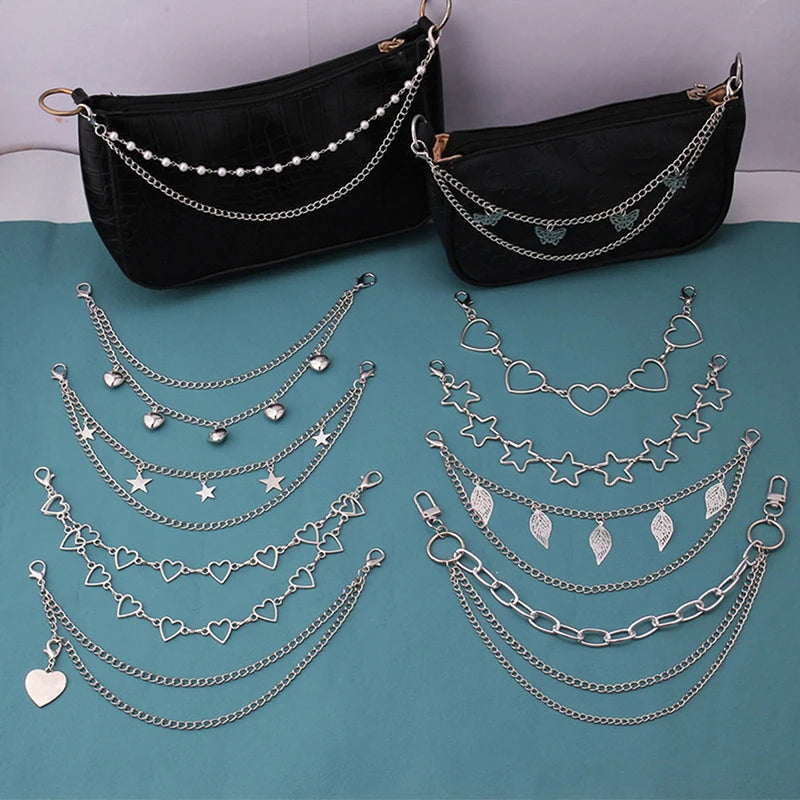 A display of multi-layer silver metal chain strap shoulder bags and charms on a teal background.
