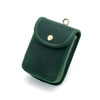 A dark green leather waist bag with gold hardware and stitching, shown from above.