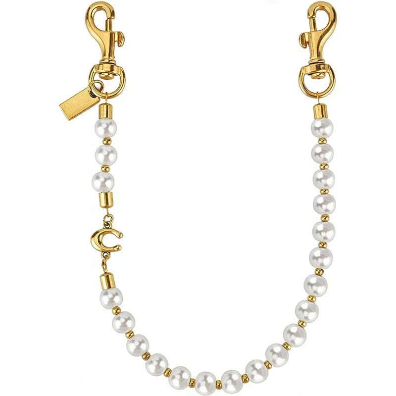Gold letter charm necklace featuring pearl beads and a clasp.