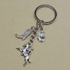 Silver keychain set featuring a cowboy boot, hat, and horseshoe charms.