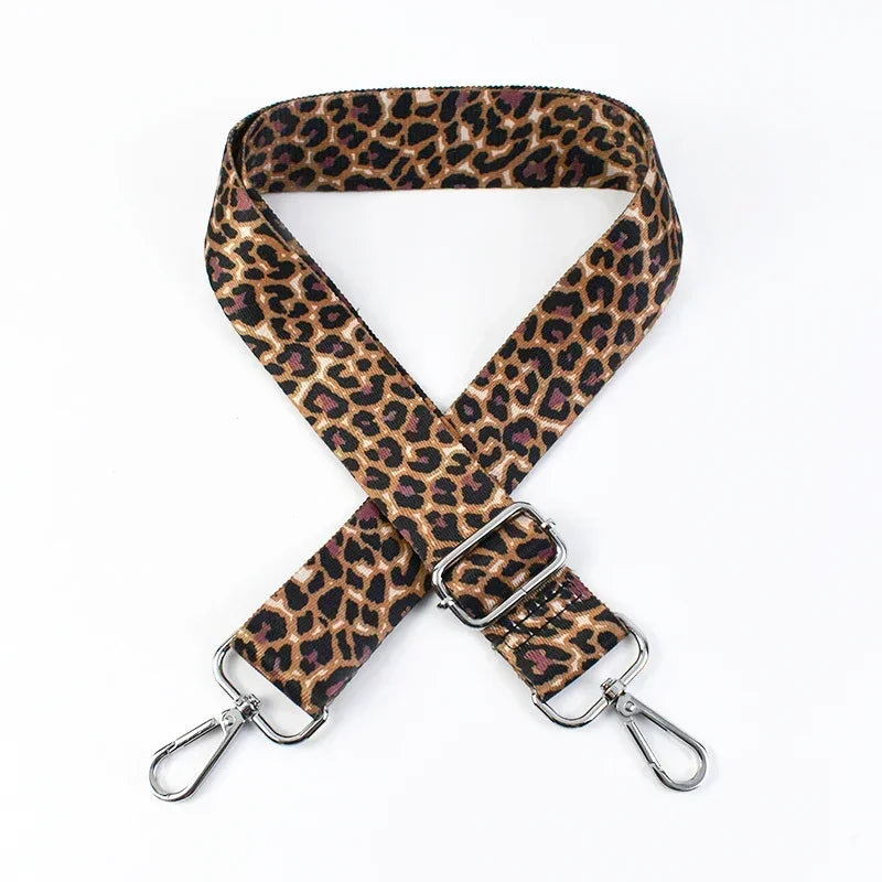 A leopard print adjustable crossbody strap for bags with silver hardware.