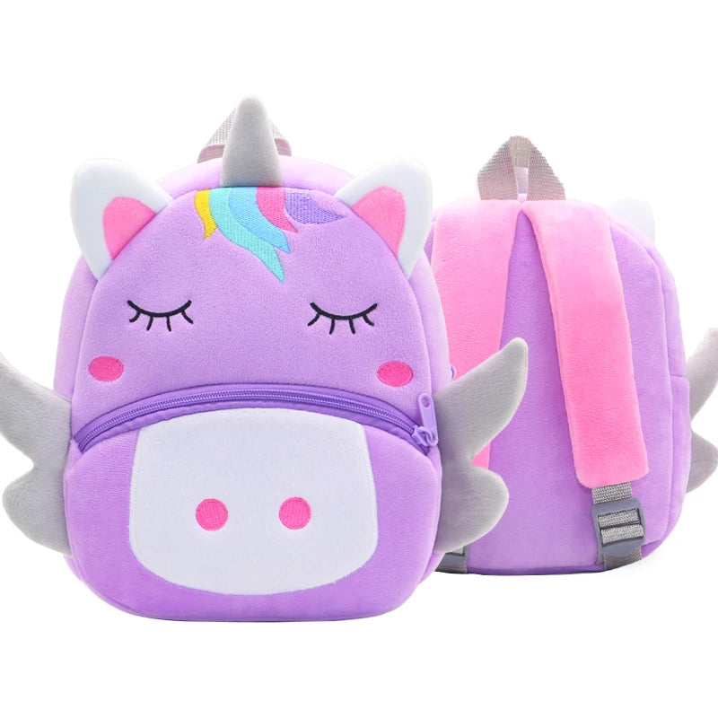 A purple unicorn plush backpack with pink accents and a rainbow horn.