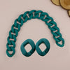 A teal acrylic chunky chain shoulder strap is displayed against a light background.