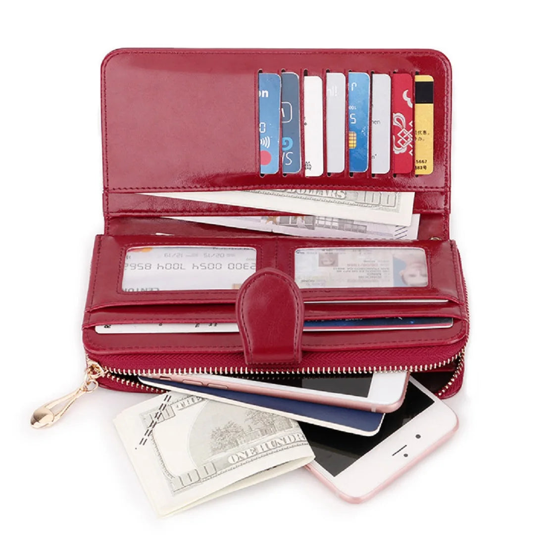 A maroon wax leather long wallet with a wrist strap is shown open, displaying various cards and holding a smartphone.