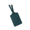 A dark teal PU leather luggage tag with a leather strap and metal clip.