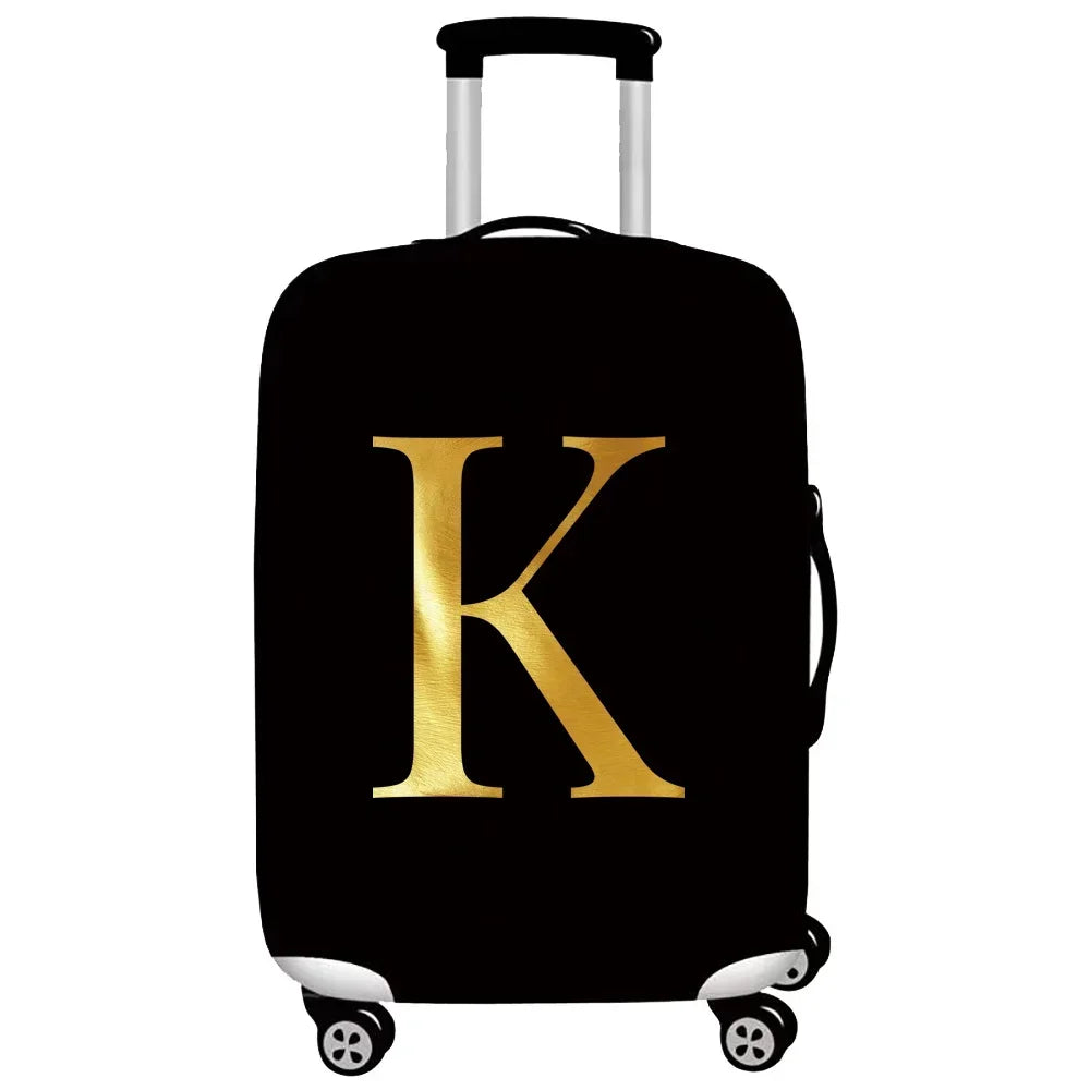 Black luggage with a gold letter K design and white handles