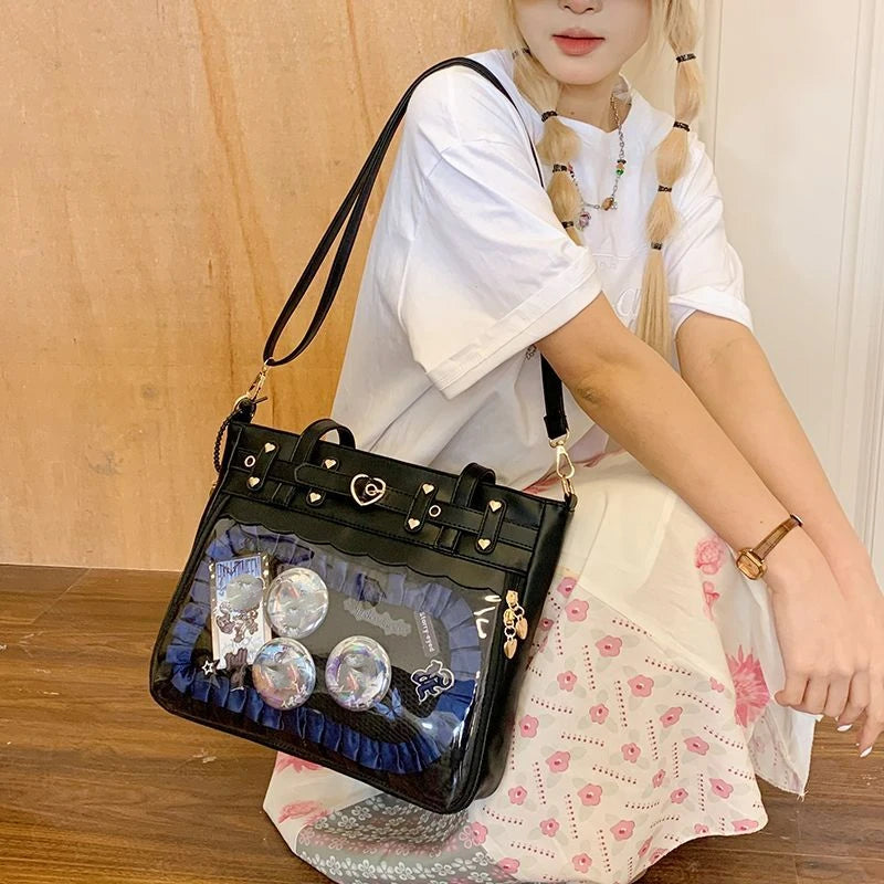 A young woman models a black Y2K punk goth crossbody bag with silver charms and iridescent embellishments.