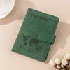 A dark green passport wallet with a world map outline and a zipper closure resting on a light surface.