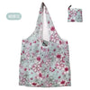 A light blue floral print tote bag featuring pink and green flowers.
