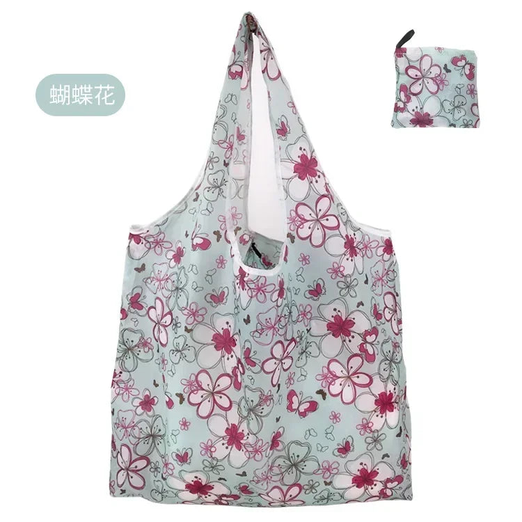 A light blue floral print tote bag featuring pink and green flowers.