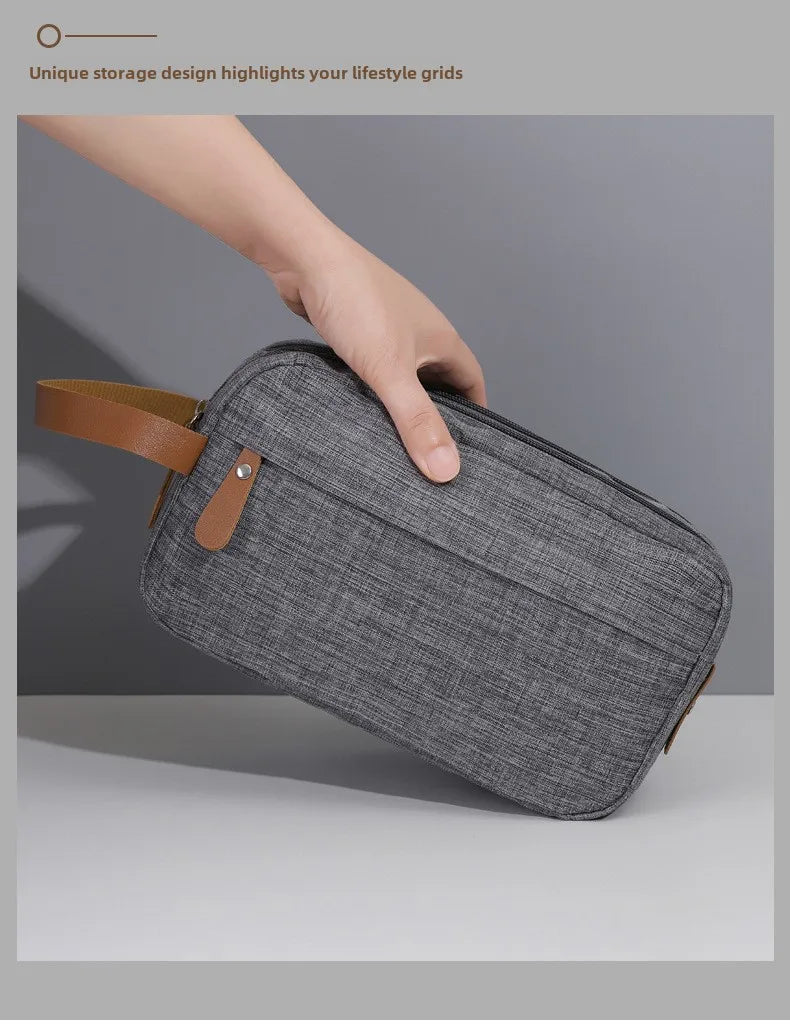 A hand is holding a gray fabric storage pouch with brown leather accents, showcasing its unique grid design.