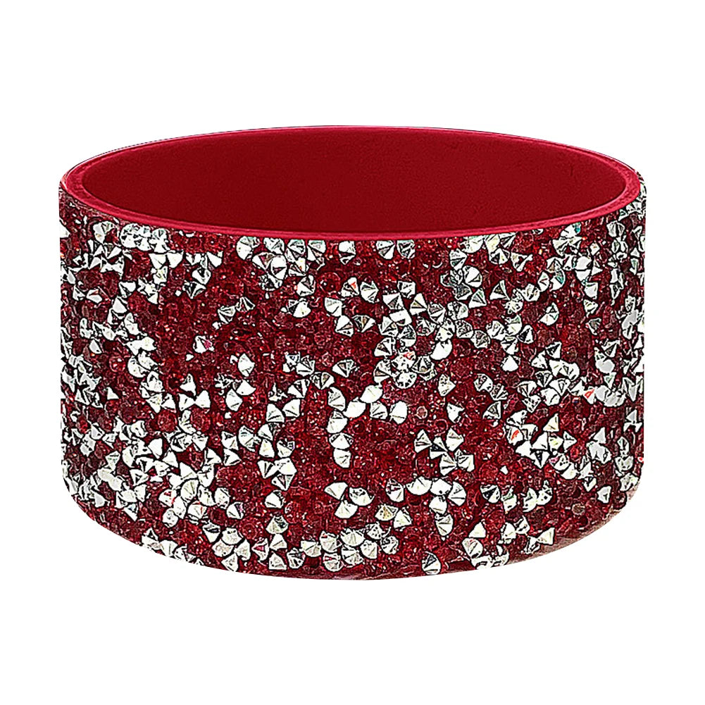 A red silicone boot sleeve for water bottles with a sparkly silver and red pattern.