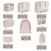 A set of seven folding storage bags in various sizes and colors for travel organization.