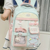 A light mint green and pink campus backpack worn by a woman.