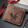 A brown embossed PU leather slim wallet with a silver clasp and a red ribbon, resting on a dark surface next to a black pen.