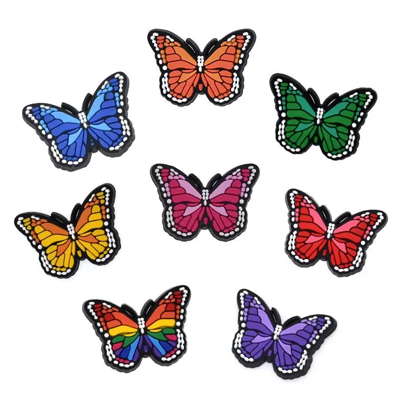 A collection of nine colorful butterfly decorative shoe charms and pins for clogs and sandals