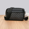 Black men's PU leather shoulder clutch bag with a subtle geometric pattern resting on a wooden surface.