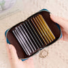 A hand holds an open brown accordion wallet with multiple protective layers for cards and IDs.
