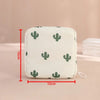 A white fabric pouch with a green cactus pattern, designed for compact sanitary pad storage.