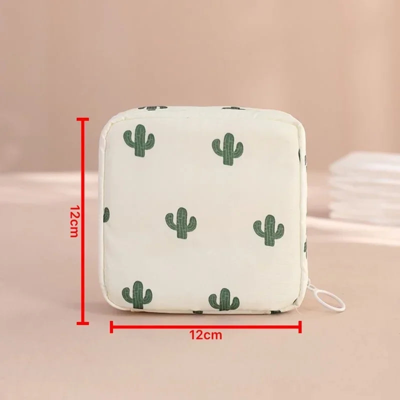 A white fabric pouch with a green cactus pattern, designed for compact sanitary pad storage.