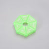A translucent lime green weekly pill organizer divided into seven sections labeled with the days of the week.