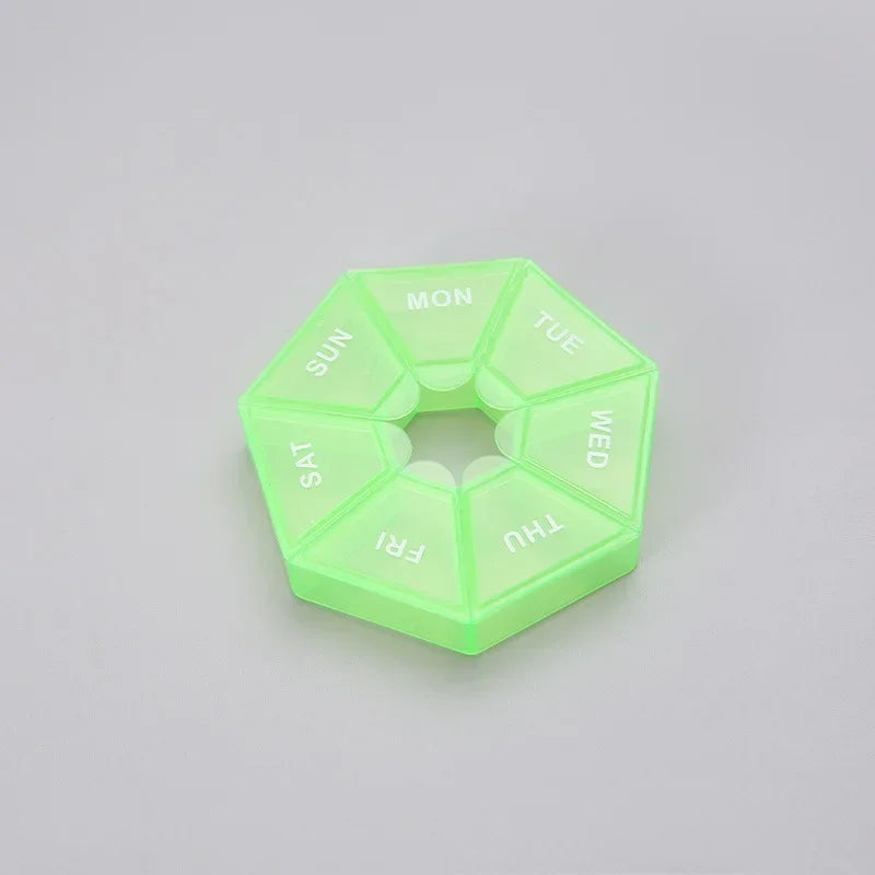 A translucent lime green weekly pill organizer divided into seven sections labeled with the days of the week.
