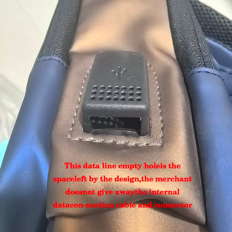 Close-up view of a dark silicone data line empty hole on a tan leather sling bag