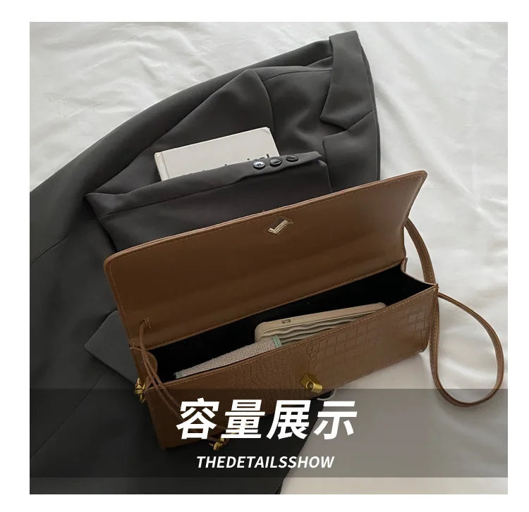 A brown crocodile-embossed PU leather clutch bag is shown open inside a gray blazer pocket.