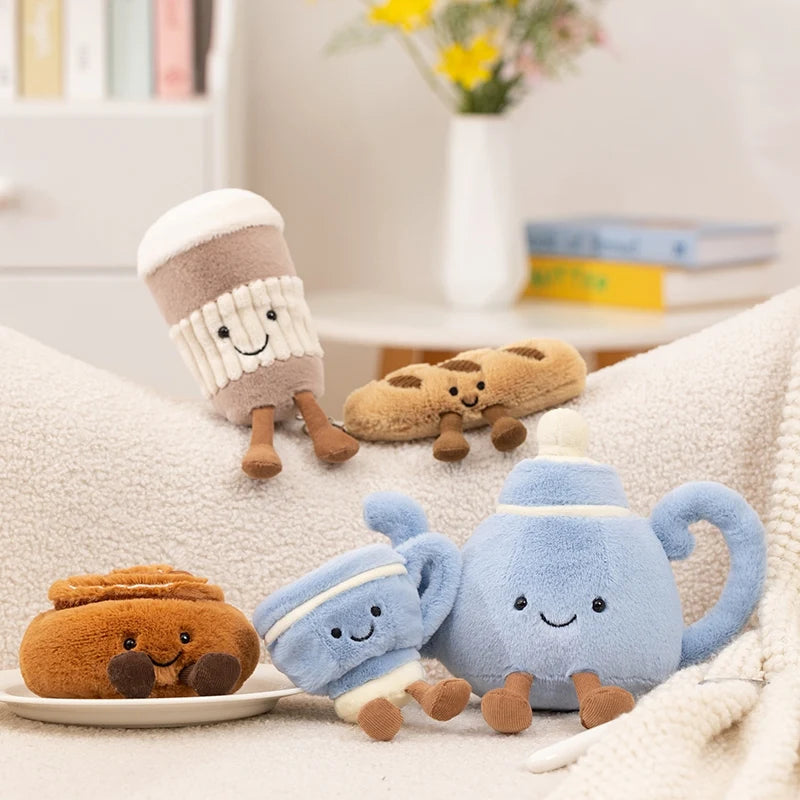 A collection of soft, adorable cartoon character plush toys in various colors and shapes resting on a white surface.