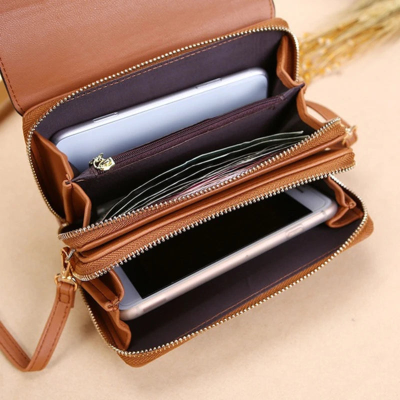 A brown leather shoulder wallet is open, displaying a smartphone and a card slot.
