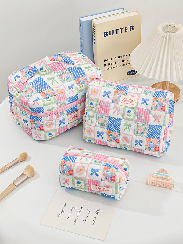 A pink and blue patchwork quilted makeup bag next to a butter-themed book.
