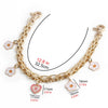 Gold metal purse chain strap with flower charms shown against a white background.