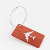 A rectangular orange luggage tag with a silver loop attached, featuring a white airplane silhouette.