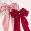 A set of elegant silk bows in pink and red for hair accessories.