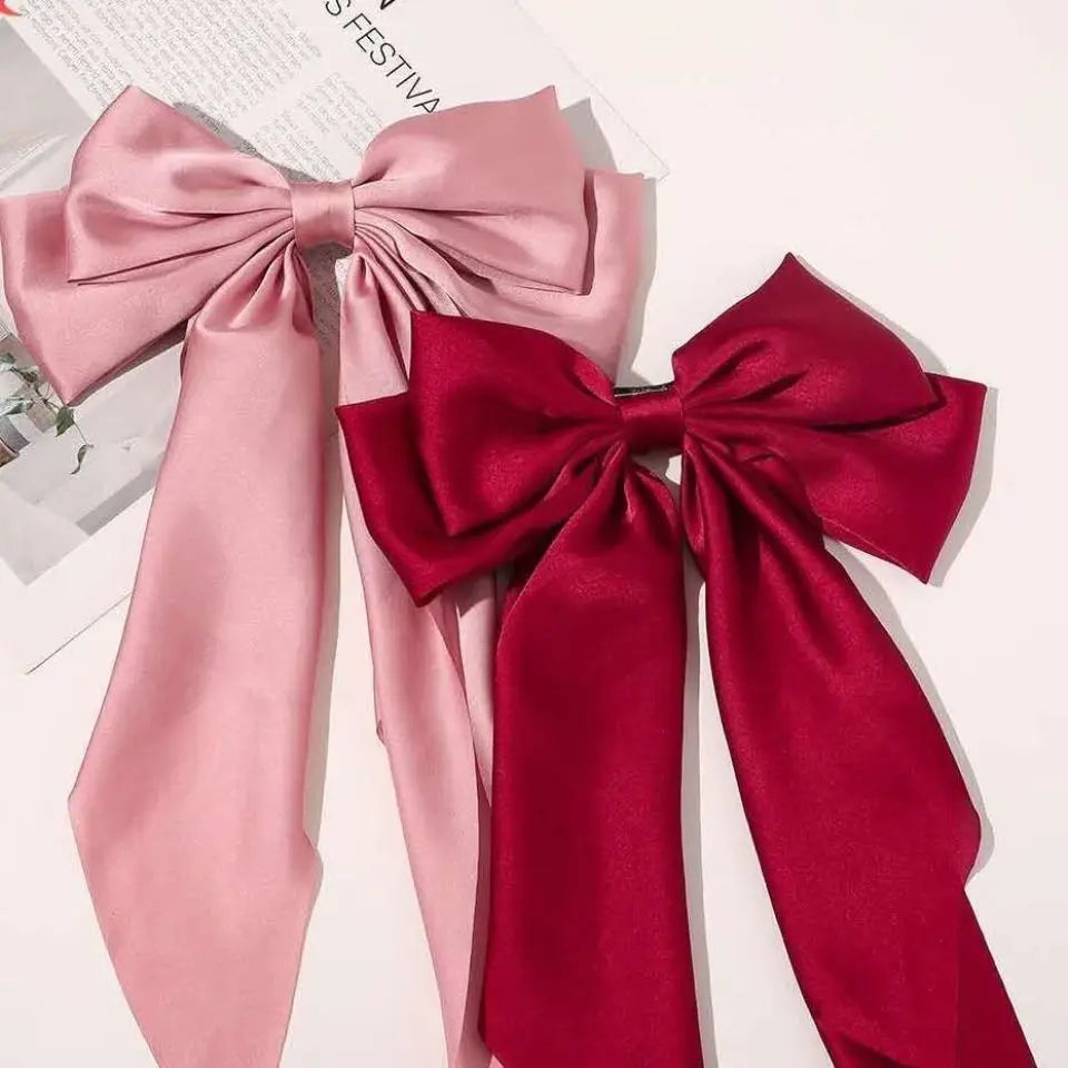 A set of elegant silk bows in pink and red for hair accessories.
