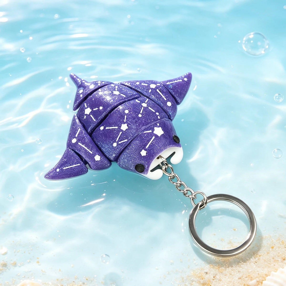 A purple, starry devil ray figurine is shown floating on clear blue water.