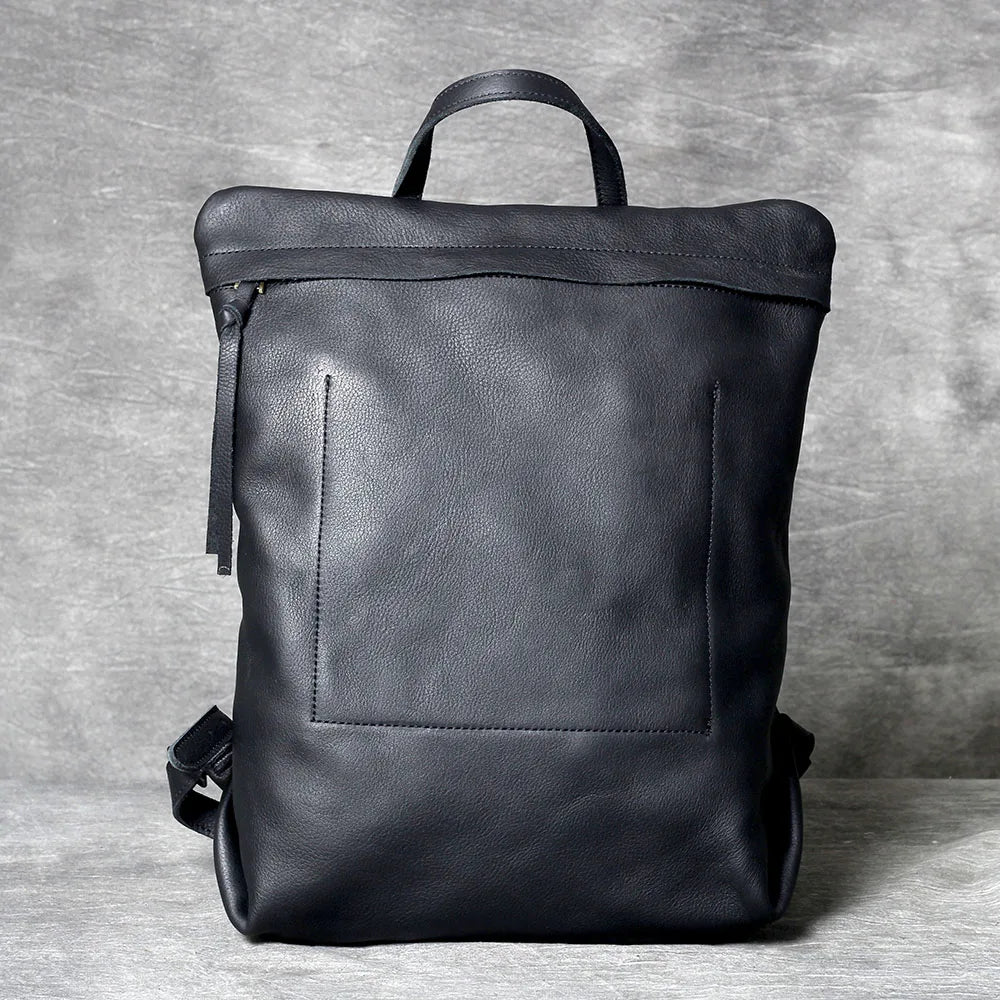 A black genuine full-grain leather backpack shown from the back.