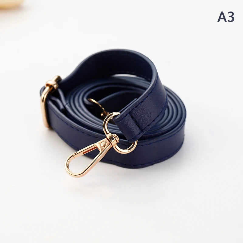 A dark navy blue PU leather strap with a gold-toned clasp coiled on a white background.