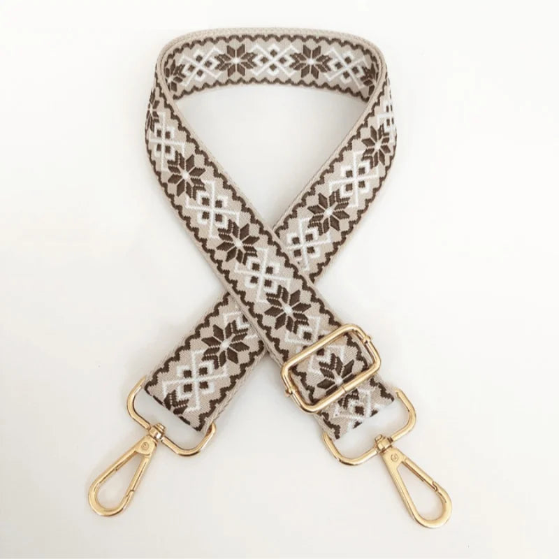 A beige and brown patterned replacement bag strap with gold-toned adjustable hardware.