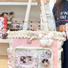 A pink transparent shoulder tote bag with white straps and decorative lace details.